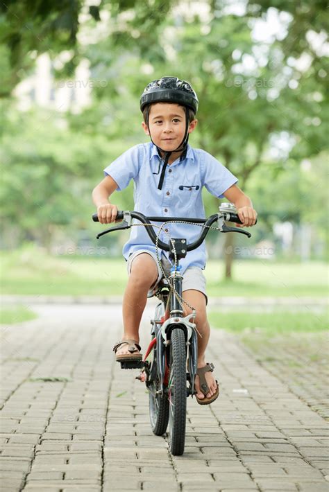A Boy Riding A Bicycle Bicyklez