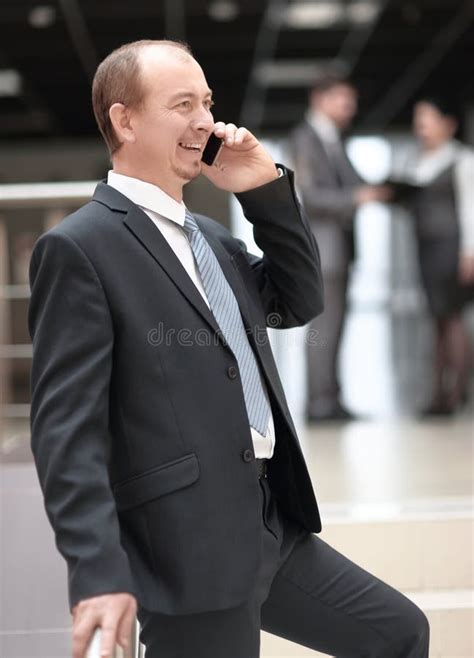Smiling Businessman Talking On Mobile Phone In Office Stock Image