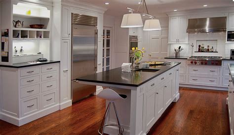 It also includes a wooden raised counter aligned with bar stools. White Luster Kitchen Cabinets | Plain & Fancy Cabinetry