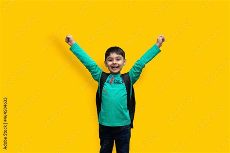 Cute 7 Year Old Happy Boy With School Backpack Holding Books In Plain