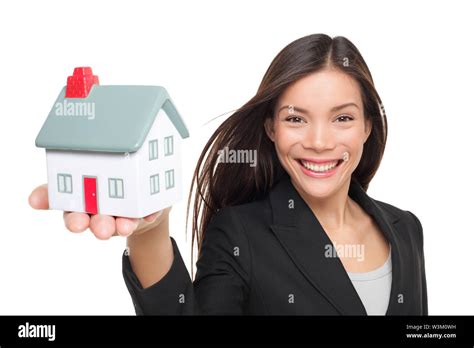 Real Estate Agent Selling Home Holding Mini House Female Realtor In Business Suit Smiling Happy