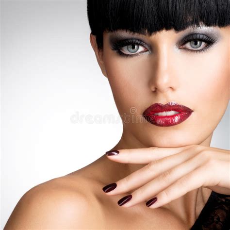 Face Of A Woman With Beautiful Dark Nails And Red Lips