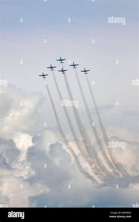 The Polish Air Force Orlik Aerobatics Team Flying Over Cloudy Sky During International Air Show