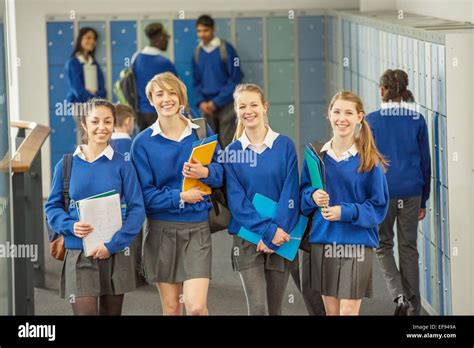 Portrait Of Smiling Female Students Wearing School Uniforms Walking