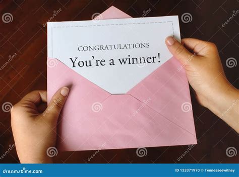A Letter That Says Congratulations You`re A Winner With Hands Holding