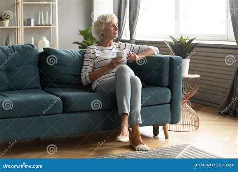 Calm Mature Woman Relax On Couch Drinking Tea Stock Image Image Of