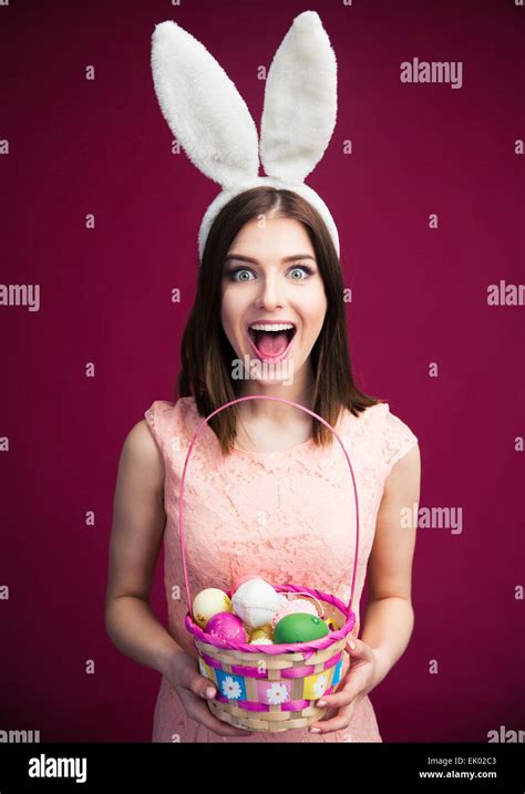 Happy Young Woman With Bunny Ears And Easter Egg Basket Looking At