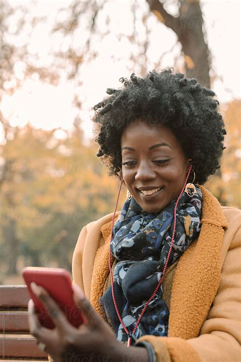 Afro Woman Listening Music With Earphones By Stocksy Contributor Ani