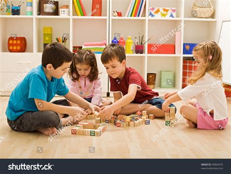 Children Playing With Blocks On The Floor Focus On The Boys Face