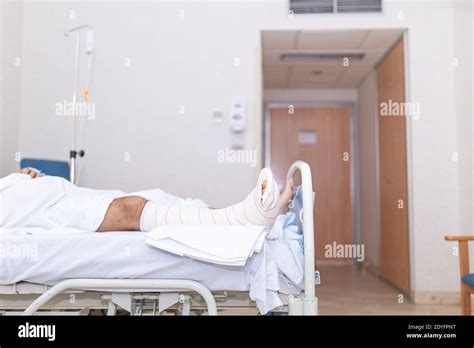 Patient Lying In Hospital Bed With Broken Leg Hospitalization And Medical Care Concept Stock