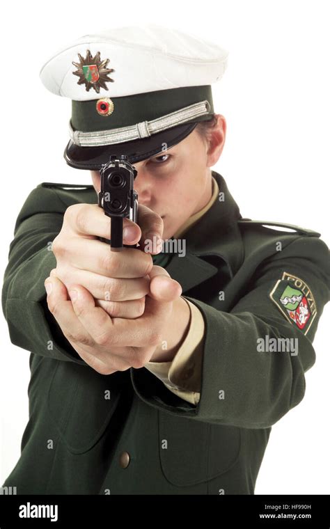 Young Policeman With Gun At The Ready Stock Photo Alamy