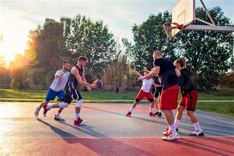 Group Of Young Friends Playing Basketball Match Stock Image Colourbox