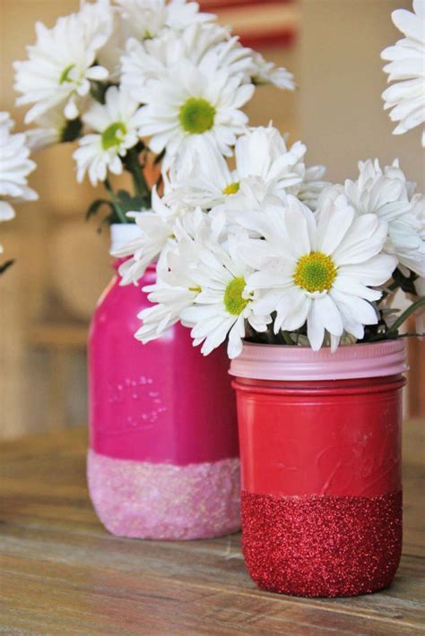 A chandelier made of super cute mason jars will surely work as a focal point in any interior. DIY Glitter Mason Jar Vases - craft - Little Miss Momma