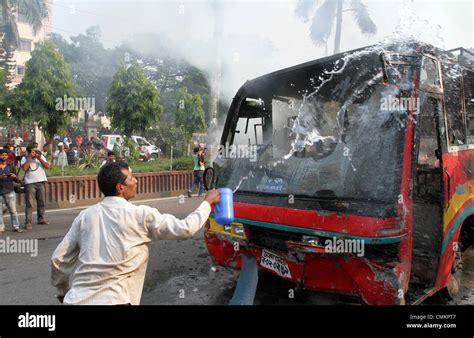 Dhaka 3rd Nov 2013 A Bangladesh Man Throws Water At A Bus Set Alight