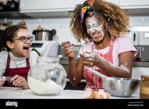 Mom And Daughter Play With Flour While Preparing Sweets At Home