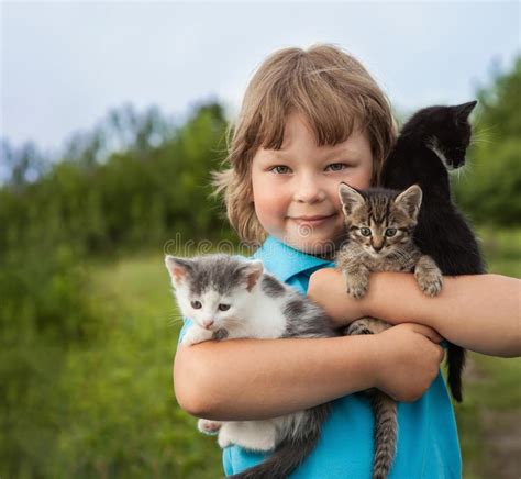 Kitten On Arm Of The Boy Outdoors Child Huge His Love Pet Stock Image