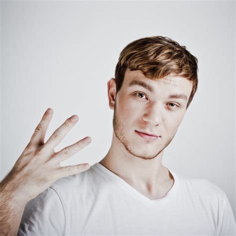 Young Man Holding Up Two Fingers — Stock Photo © Porechenskaya 8395239
