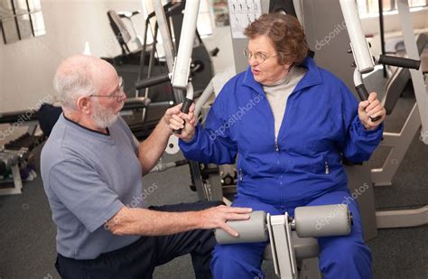 Senior Couple Working Out In The Gym — Stock Photo © Feverpitch 2348732