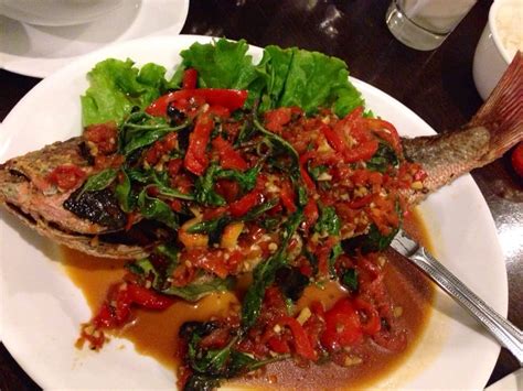 Carefully place the fish in the pan and fry until browned and crisp, about 5 minutes per side. Fried red snapper topped with chili, garlic and basil. - Yelp