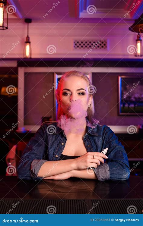 Young Pretty Woman Smoke An Electronic Cigarette At The Vape Bar Stock Image Image Of Indoor
