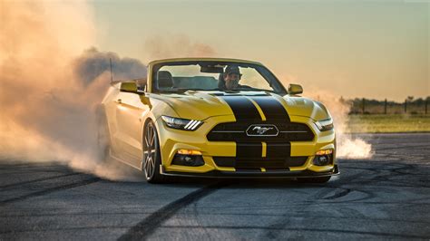 man riding yellow ford mustang convertible with tires screeching during daytime hd wallpaper
