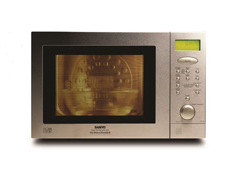 A Silver Microwave Oven With The Door Open And Yellow Light On Its Side