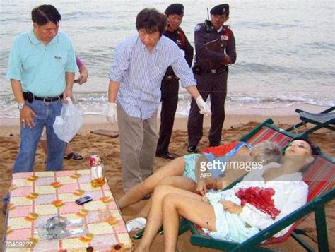 Thai Policemen Inspect The Bodies Of Two Russian Tourists At Jomtien