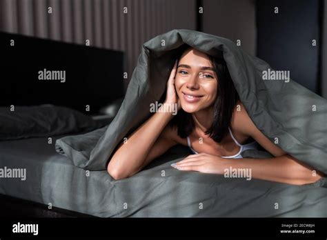 Beautiful Woman In Bed Under The Sheets Stock Photo Alamy