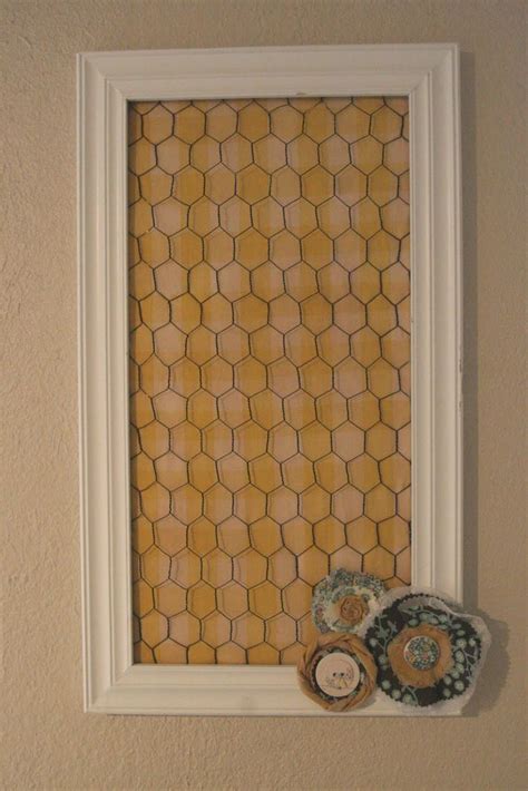 A Window Frame With Some Buttons On The Side And A Wall Hanging In