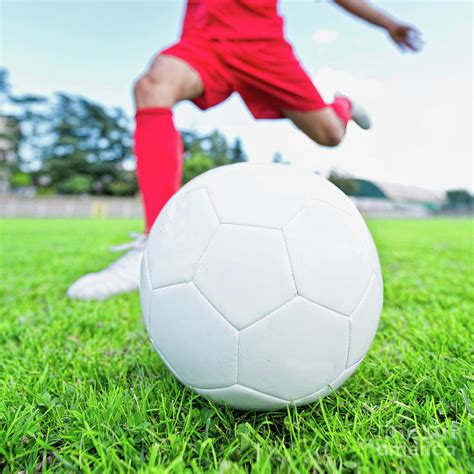 Soccer Player Kicking Ball Photograph By Microgen Imagesscience Photo