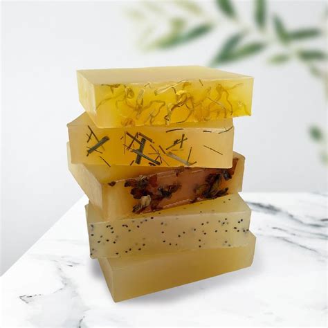 Three Soap Bars Stacked On Top Of Each Other With Yellow Flowers In The
