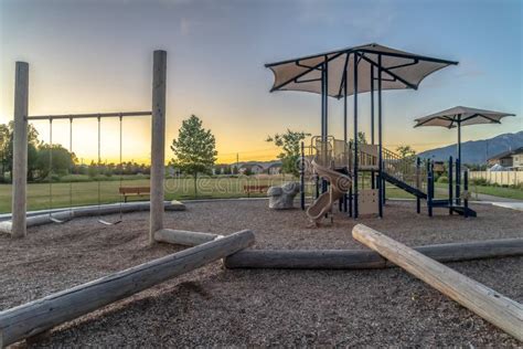 Neighborhood Park With Fun Playground Featuring Slides And Swings For