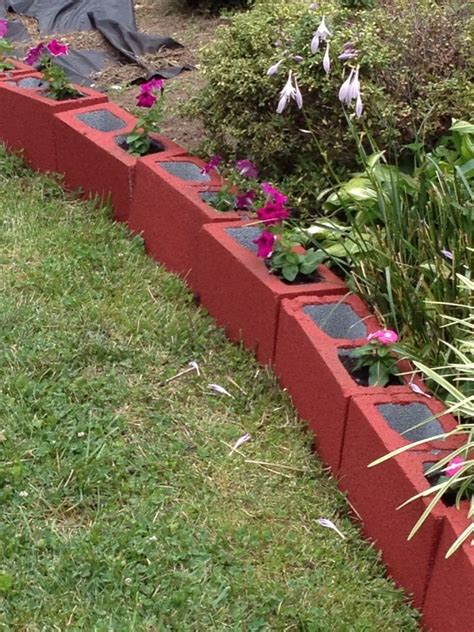 From plant labels to mounted garden beds, these projects will make your gardening experience extraordinary! Painted cinder blocks as an edge for landscaping | Painted ...