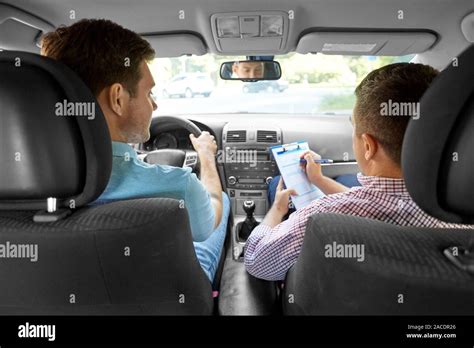 Car Driving Instructor With Clipboard And Driver Stock Photo Alamy