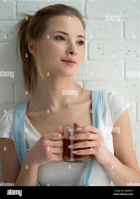 Smiling Young Woman Holding Coffee Cup High Resolution Stock