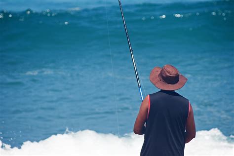 Fisherman Fishing On A Beach Free Stock Photo Public Domain Pictures