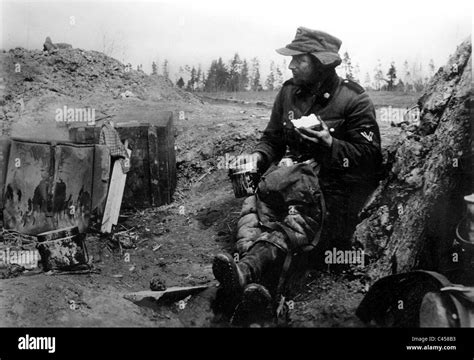 A Soldier Of The Waffen Ss Takes A Food Break 1942 Stock Photo Alamy