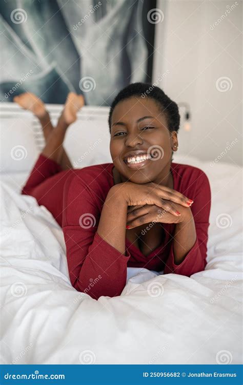 Portrait Black African Woman Laying On Bed Smiling Looking Into Camera