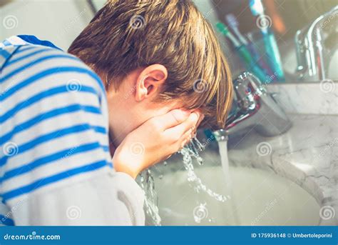 Boy Wash His Face In The Bathroom New Day Of Everyday Life Stock Photo
