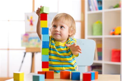 Child Boy Playing With Block Toys In Day Care Center Stock Image