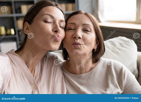 daughter her mother looking at camera blowing kisses webcam view stock image image of older