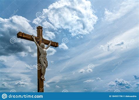 Jesus Christ On A Wooden Cross Dramatic Sky Background With Clouds