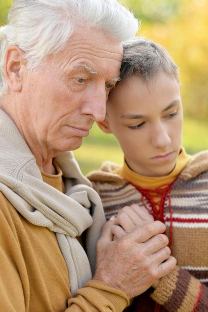 Premium Photo Sad Grandfather And Grandson Hugging