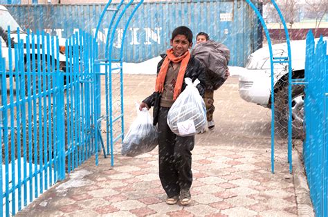 Orphans Help Carry Loads Of Donated Winter Clothes Into The Facility
