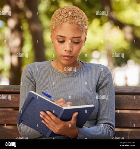 Woman Student Writing In Notebook And Studying From Diary Journal Or