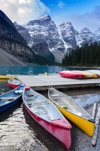 Premium Photo Colorful Canoes Docked At Moraine Lake In Banff