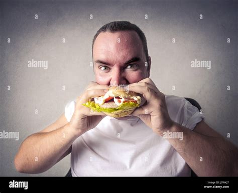 Obese Man Eating Hamburger Stock Photo Alamy