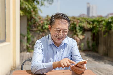 Grandpa Playing Cell Phone Outdoors Picture And Hd Photos Free Download On Lovepik
