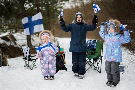 Three Finnish Children With Finland Flags On A Nice Winter Day Nordic