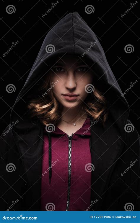 Close Up Portrait Of A Secretive Young Girl In A Deep Dark Hood On A